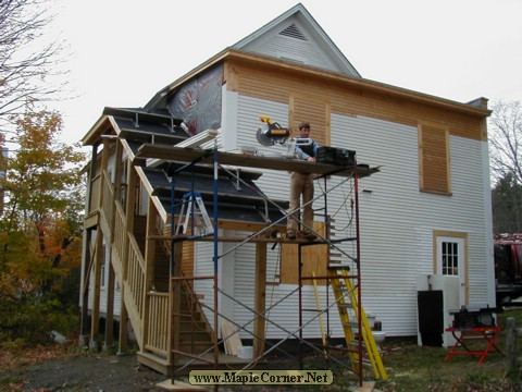 Mark Whitman cuts new clapboards