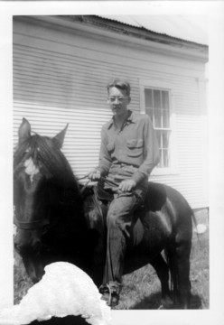 on horse in front of Ira Morse house